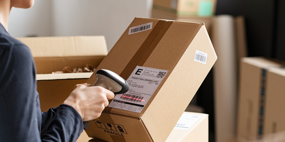 woman scanning a delivery of boxes