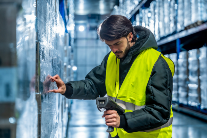 Warehouse worker scanning a large item with a handheld device</p>
<p>Digital product passport furniture retail